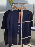 Load image into Gallery viewer, Side angle of Humble Human navy blue relaxed oversized men’s t-shirt in natural light