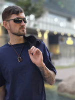 Load image into Gallery viewer, House of SwaSha navy blue oversized men’s t-shirt back view on model showing relaxed fit and clean lines with a blurred background