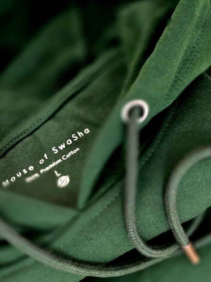 Close-up of Limitless hunter green hoodie hood and drawstrings showing fabric texture and stitching