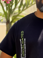 Load image into Gallery viewer, Close-up of “Unvalidated” text graphic print on House of SwaSha black men’s classic fit T-shirt chest, minimalist design, premium sustainable fabric weave visible