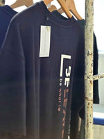 Load image into Gallery viewer, Side angle of BeLeaver charcoal black oversized men’s t-shirt in natural light