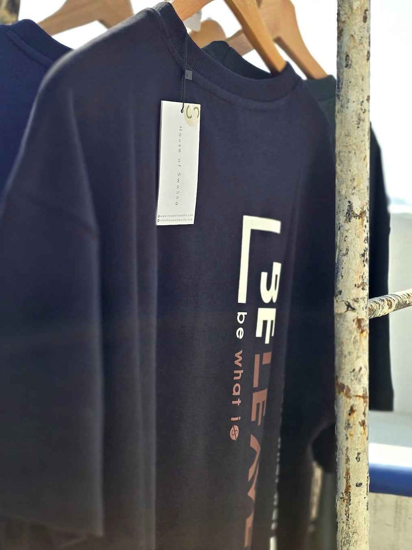 Side angle of BeLeaver charcoal black oversized men’s t-shirt in natural light