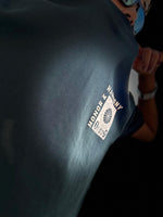 Load image into Gallery viewer, Honour and Harmony hunter green oversized men’s t-shirt three-quarter front angle on model highlighting chest graphic