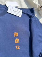 Close-up of Humble Human navy blue oversized t-shirt showing round neck and soft organic cotton fabric texture