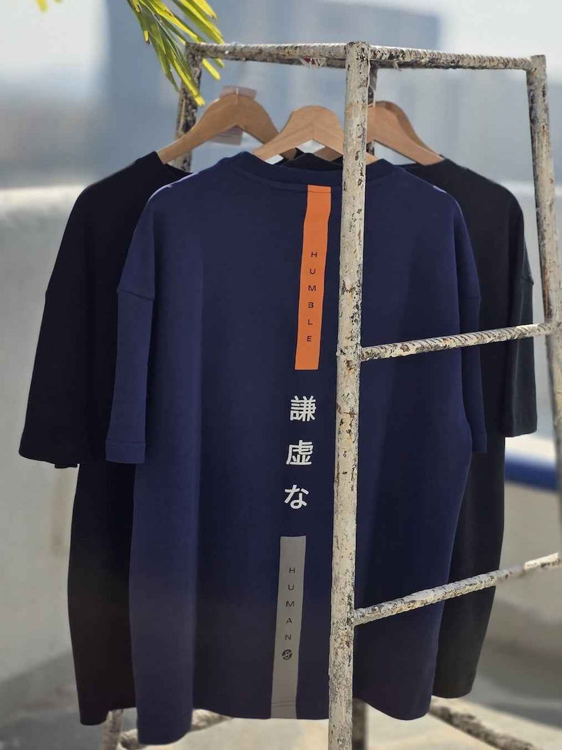 Side angle of Humble Human navy blue relaxed oversized men’s t-shirt in natural light