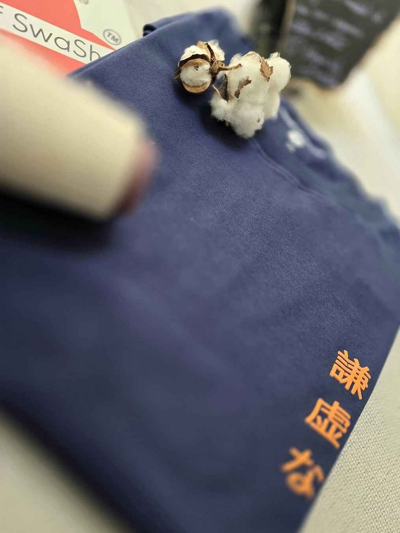 Humble Human navy blue oversized men’s t-shirt folded and focusing on the front Japanese text print