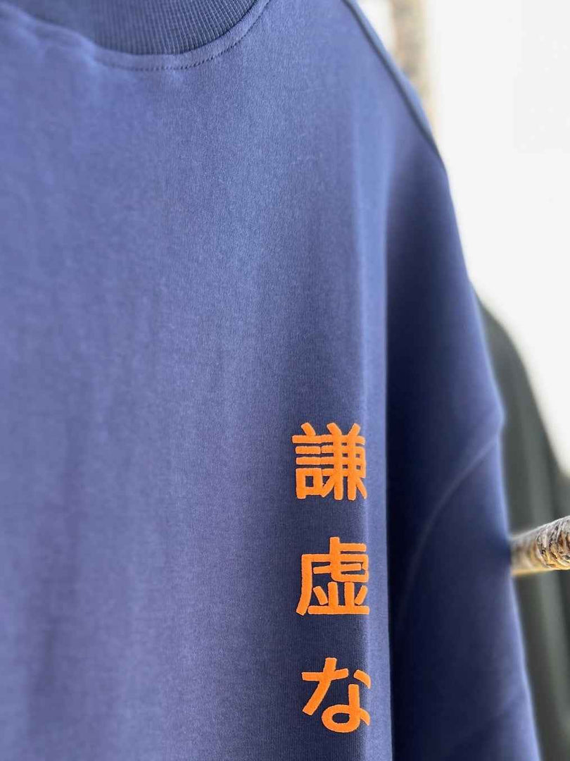 Detailed shot of the Japanese Text print of the Humble Human tee. Non-PVC Ink ensures sustainable and mindful fashion