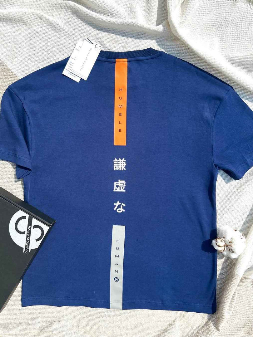 Flat lay of Humble Human navy blue oversized men’s t-shirt showing full garment shape and proportions focusing on the back print.