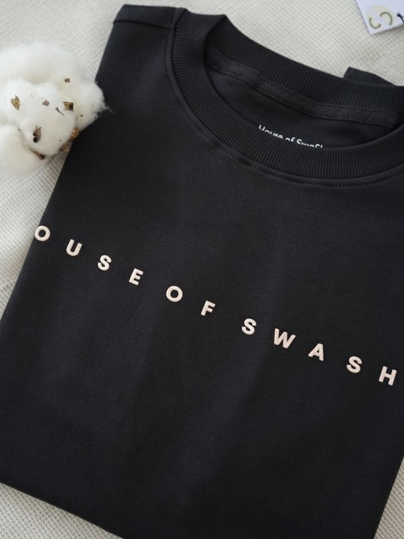 Close-up of House of SwaSha hunter green oversized men’s t-shirt featuring chest branding with non-PVC ink print
