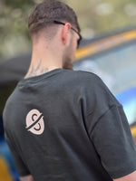 Load image into Gallery viewer, House of SwaSha hunter green oversized men’s t-shirt back view on model demonstrating fabric drape and back logo
