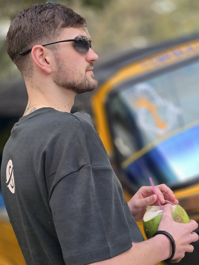 Model wearing House of SwaSha hunter green oversized men’s t-shirt as sustainable fashion casual look