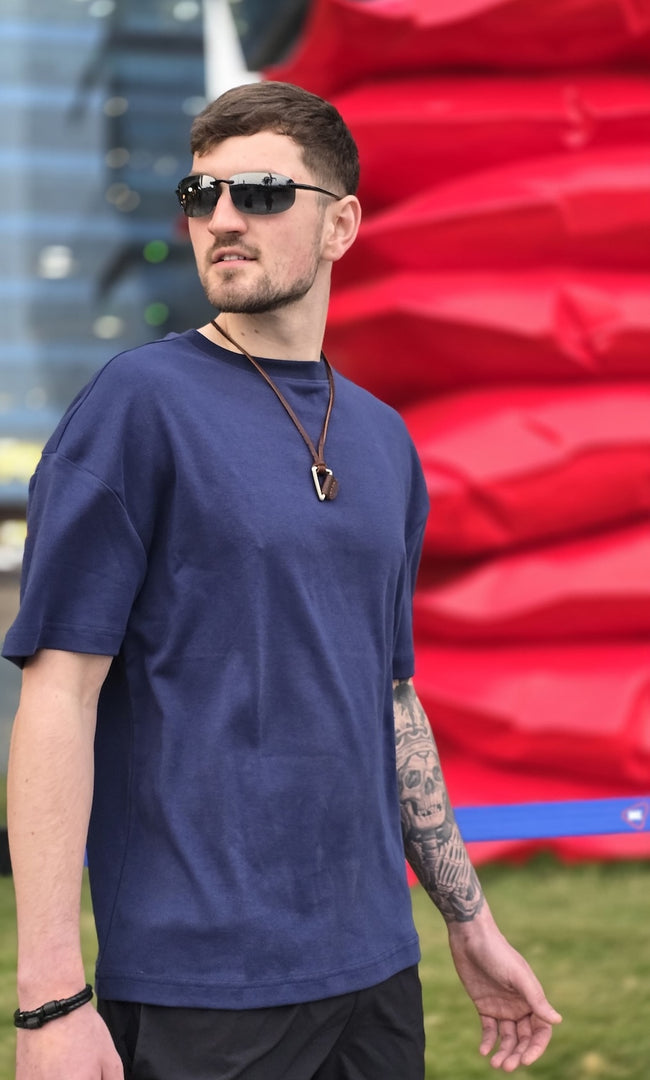 Model wearing House of SwaSha navy blue oversized men’s t-shirt as sustainable fashion casual essential